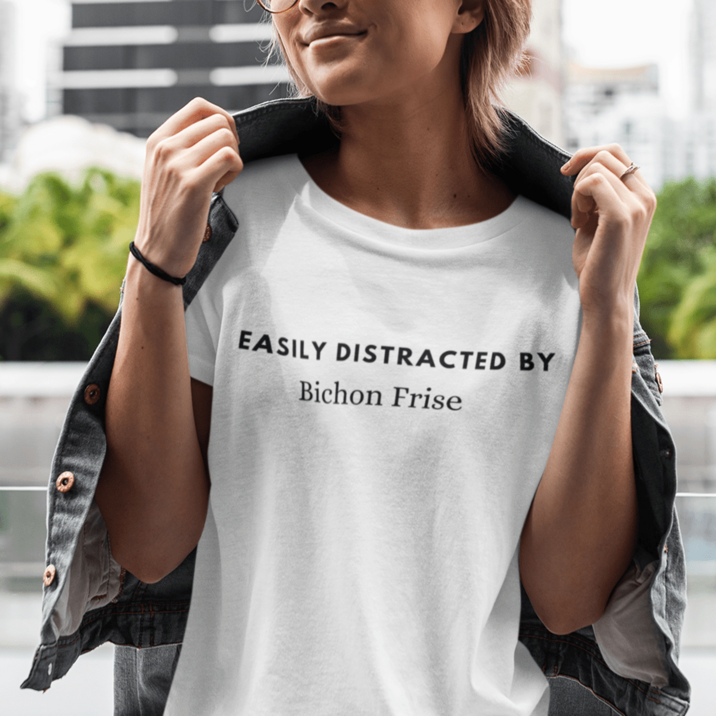"Black unisex T-shirt with playful text 'Easily distracted by bichon frise' – unique and funny dog lover shirt perfect for Bichon Frise owners and fans. Stylish casual tee for men and women who adore their bichon dogs."