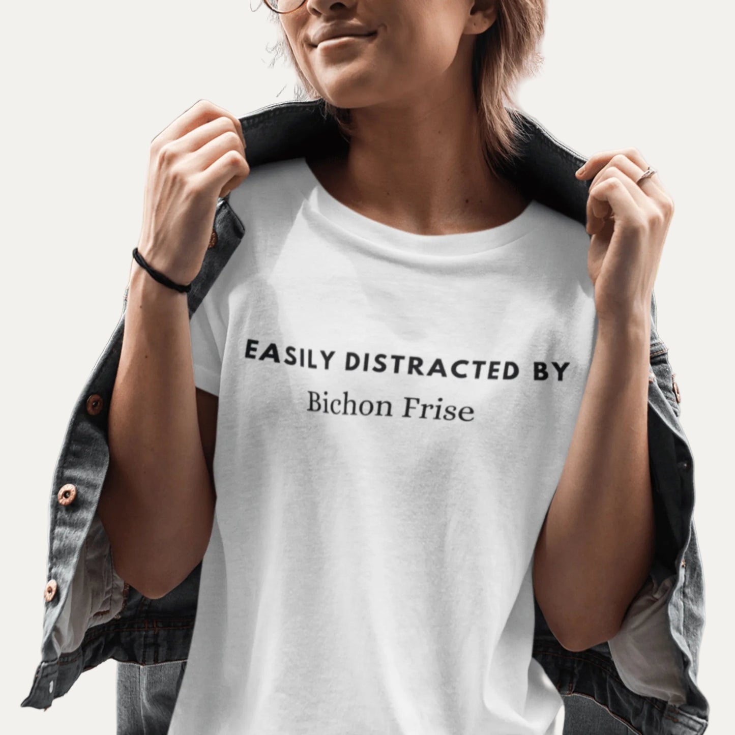 "Black unisex T-shirt with playful text 'Easily distracted by bichon frise' – unique and funny dog lover shirt perfect for Bichon Frise owners and fans. Stylish casual tee for men and women who adore their bichon dogs."