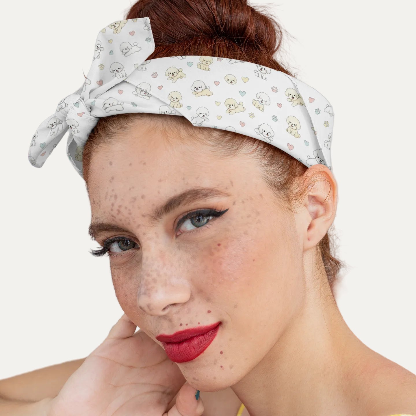 Close-up of a young woman wearing a headband-style bandana with a cute Bichon Frise dog pattern, pastel hearts and paw prints – stylish accessory mockup