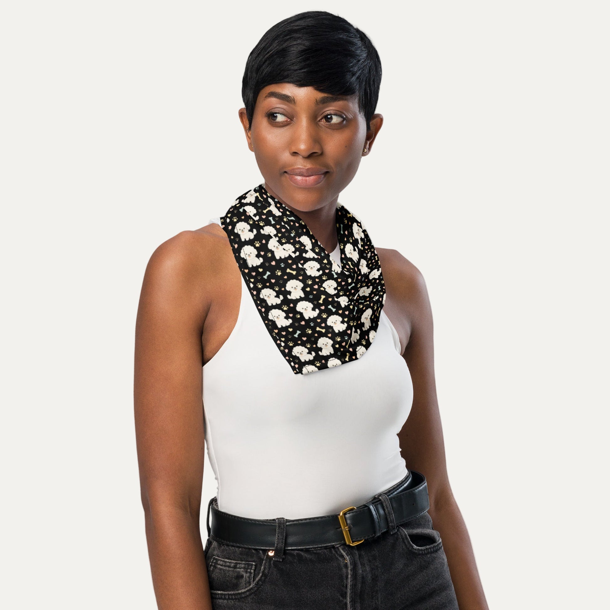 Woman wearing black bandana with cute Bichon Frise dog pattern and paw prints as stylish neck accessory