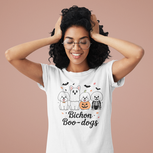 Smiling woman wearing a white Bichon Boo-dogs Halloween shirt with four cute Bichon Frise dogs in spooky costumes

