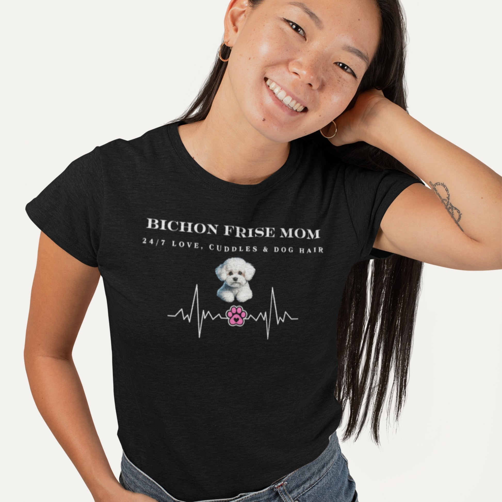 Smiling woman wearing a black T-shirt with 'Bichon Frise Mom – 24/7 Love, Cuddles & Dog Hair' and heartbeat design, perfect for dog lovers