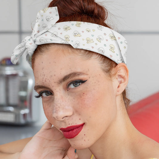 Close-up of a young woman wearing a headband-style bandana with a cute Bichon Frise dog pattern, pastel hearts and paw prints – stylish accessory mockup