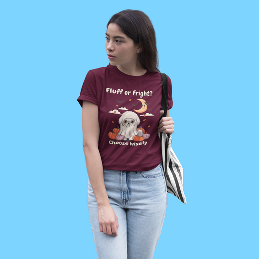 Funny Bichon Frise Halloween t-shirt with ghost costume design, shown on a burgundy shirt worn by a woman with tote bag.