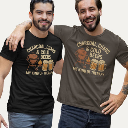 Retro-style graphic design featuring a BBQ grill, two cold beers, flames and the text "Charcoal, Chaos & Cold Beers – My Kind of Therapy" on a vintage Father's Day t-shirt.