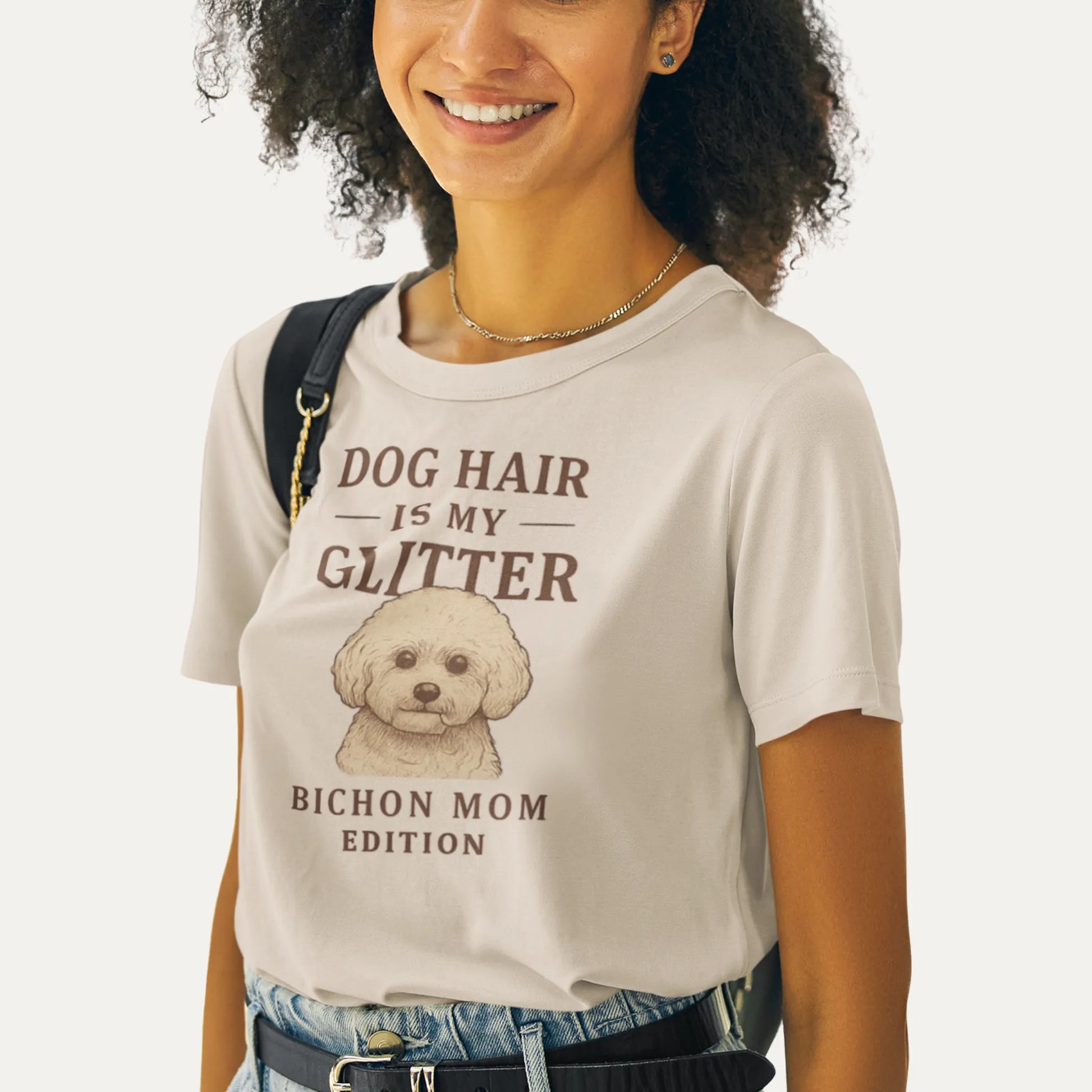 Person wearing a t-shirt with 'Dog Hair is My Glitter' text and a dog illustration.