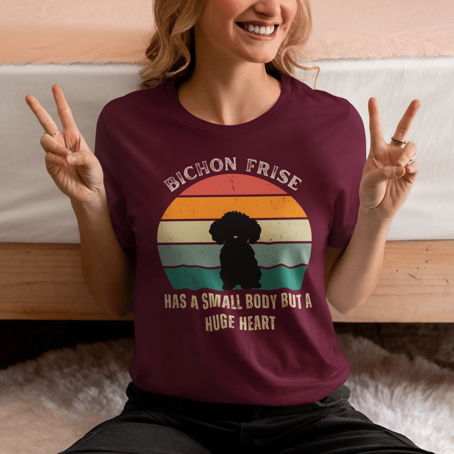 "Colorful unisex T-shirt featuring a cute black dog illustration with the quote 'Has a small body but a huge heart' – perfect for dog lovers, including but not limited to Bichon Frise fans; ideal for both men and women."