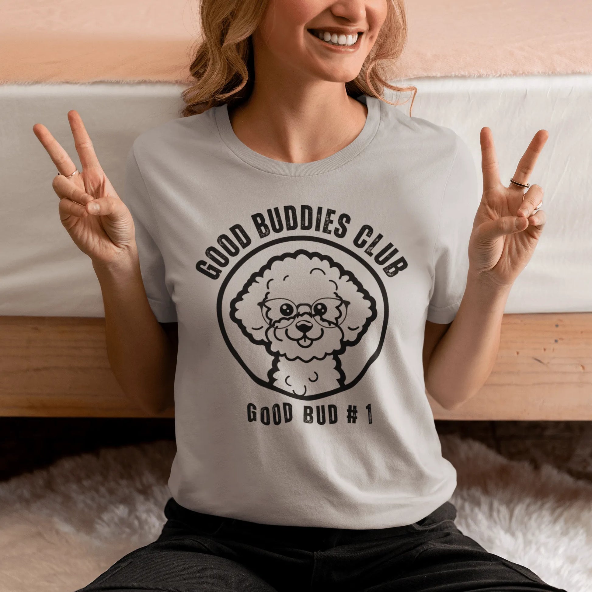 "Good Buddies Club unisex black T-shirt featuring a cheerful, happy Bichon Frise dog illustration wearing glasses, perfect for dog owners and dog lovers. Fun and unique dog-themed shirt design, ideal not only for Bichon Frise fans but all dog enthusiasts."