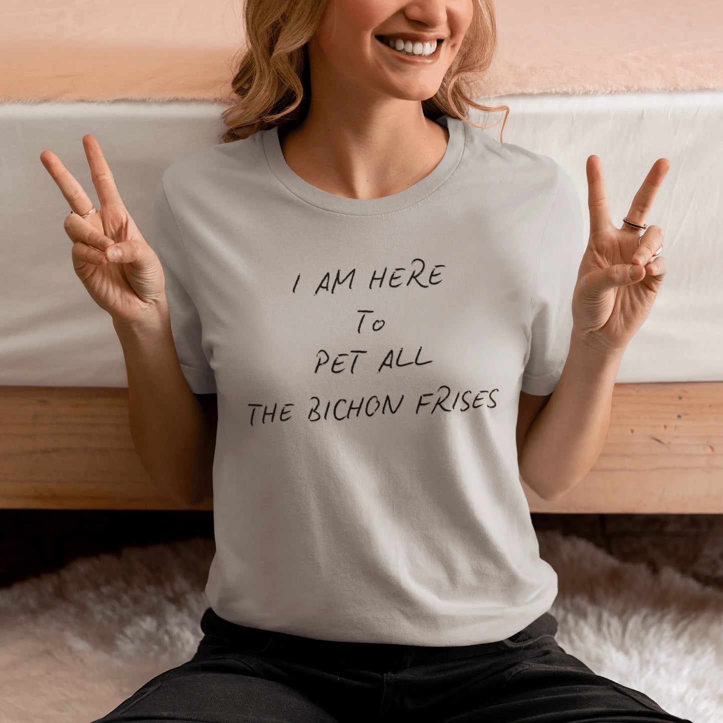 Black unisex t-shirt with the funny quote "I Am Here To Pet All The Bichon Frises" – perfect gift for Bichon Frise dog lovers, minimalist design with playful vibe.